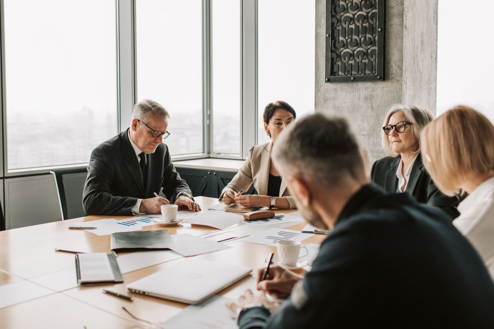 A team reviewing reports around a boardroom table