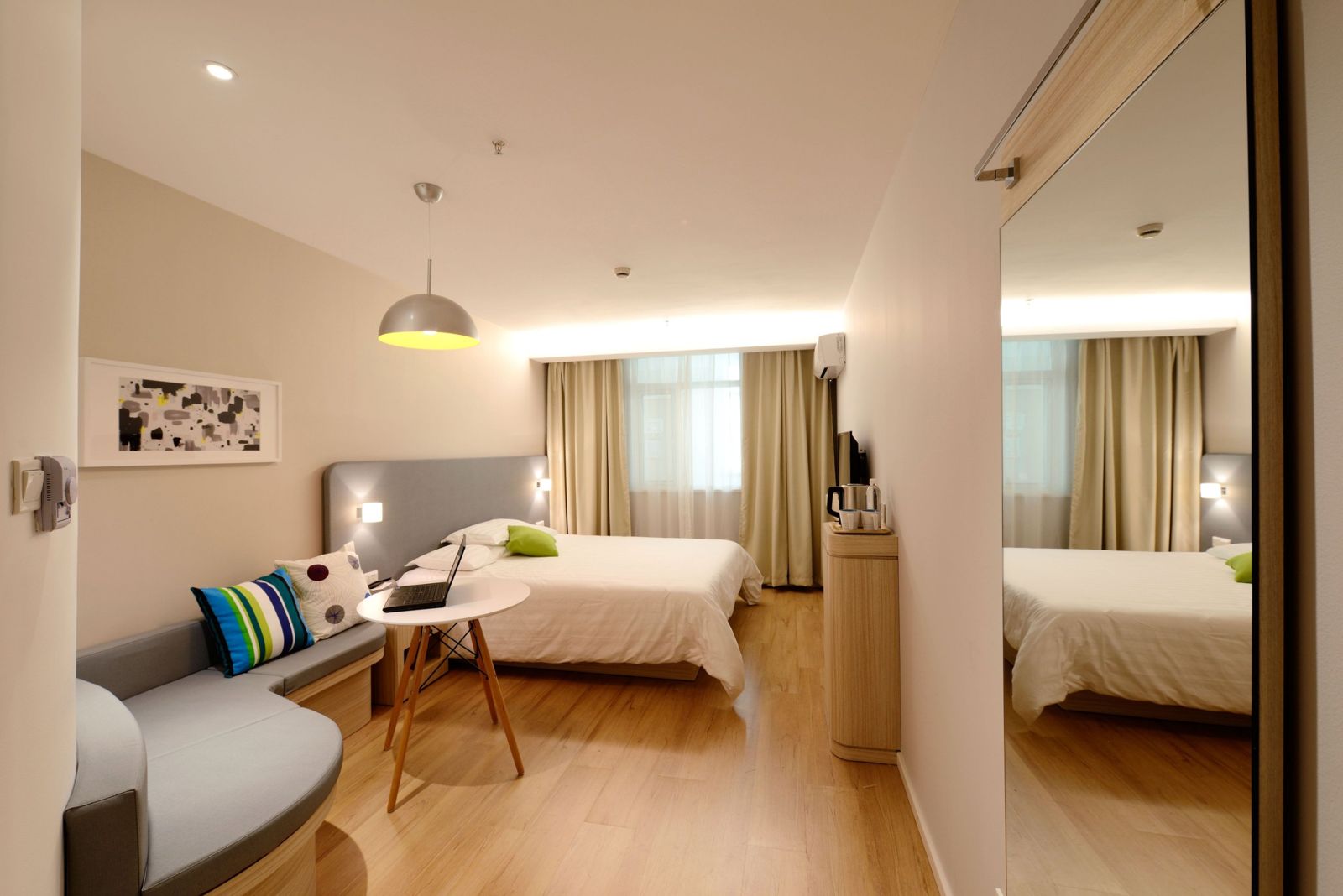 A bright, well-appointed hotel bedroom